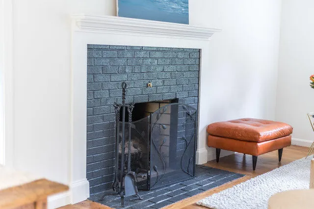 a room with a table and a fireplace