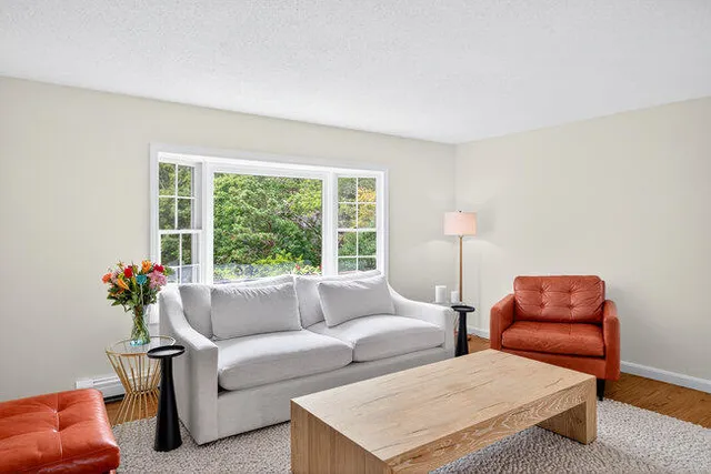 a living room with furniture and a large window