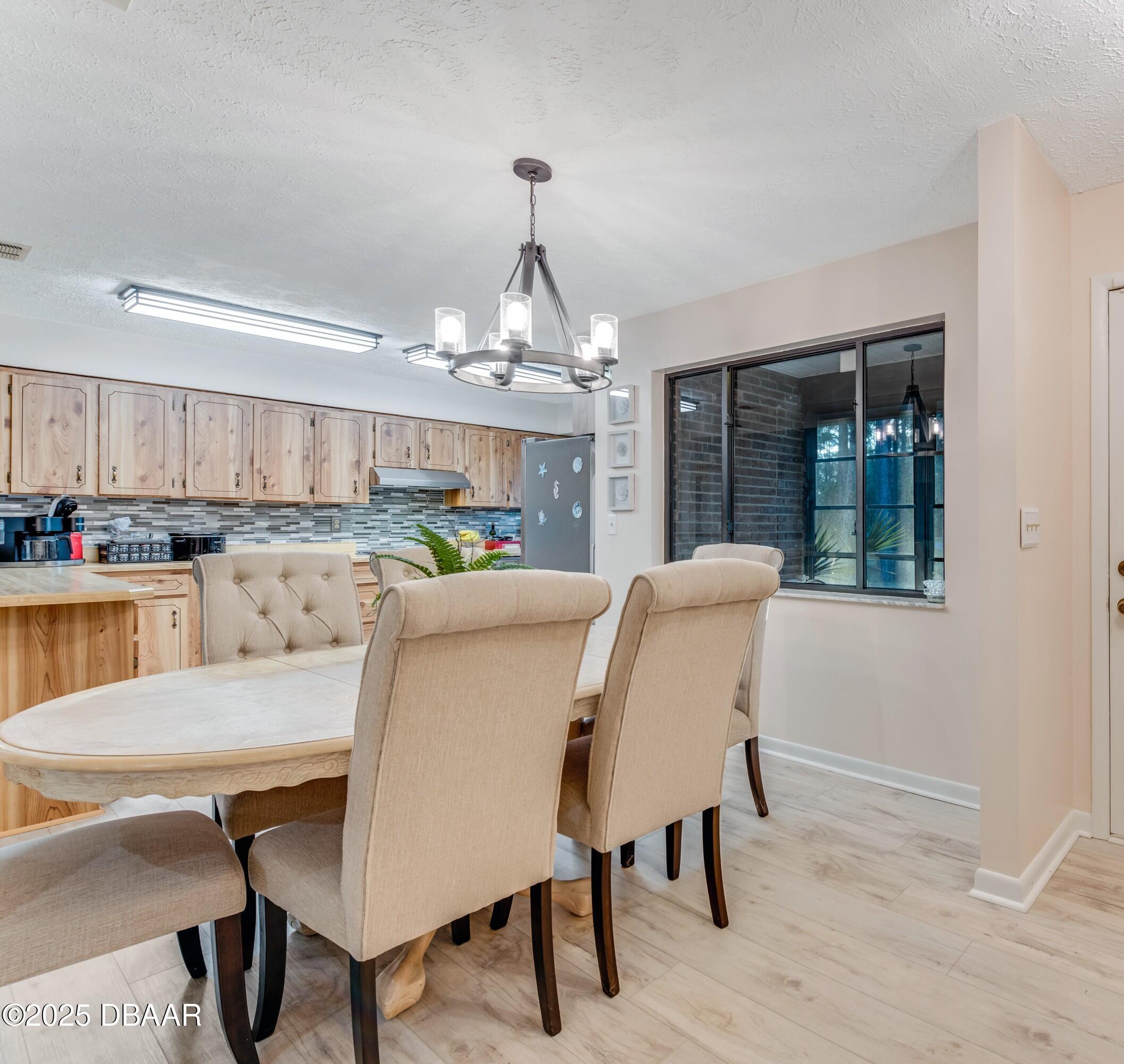 46 Winchester Road Ormond Beach, FL 32174 - Photo 22 of 92 a view of a dining room with furniture and wooden floor