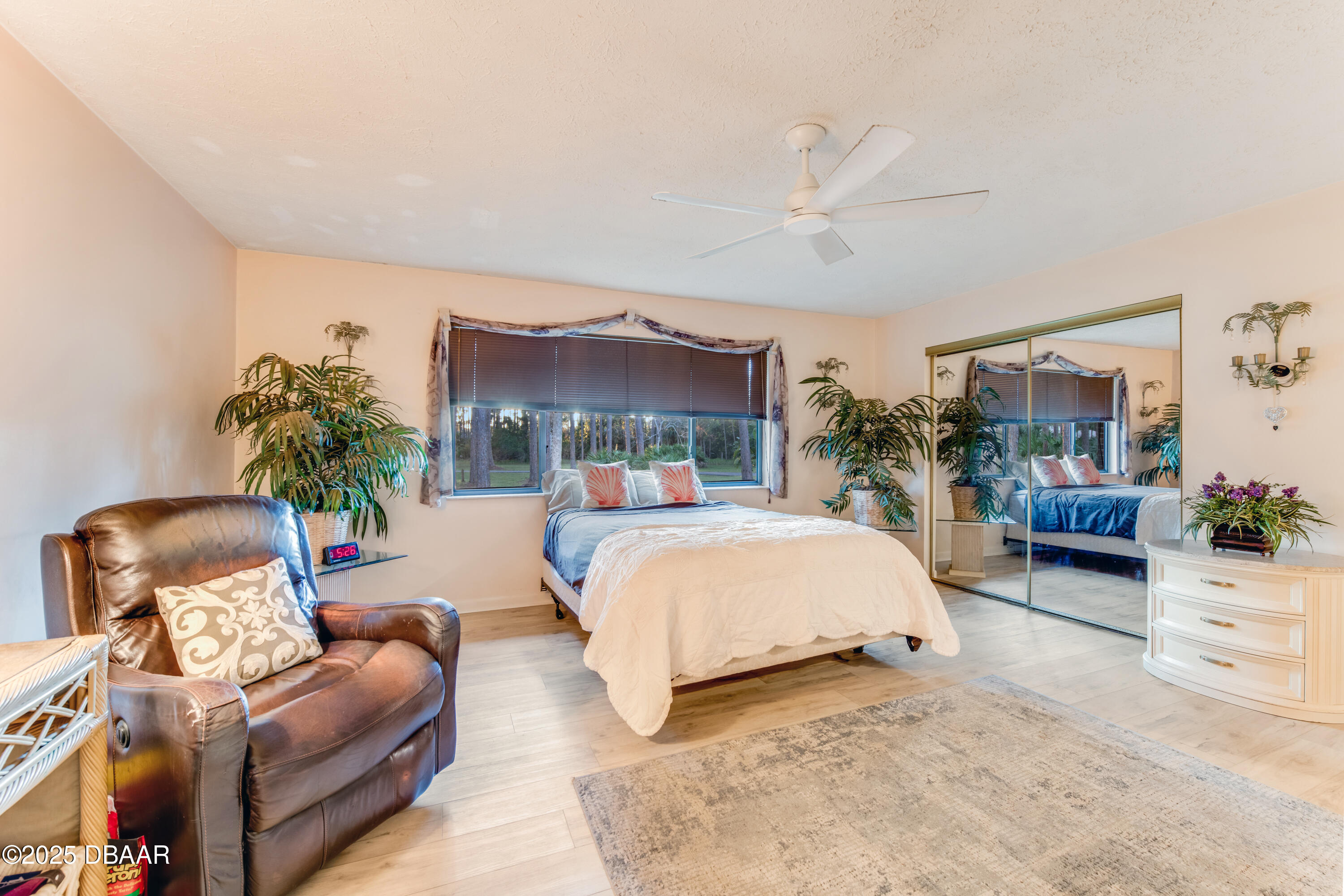 46 Winchester Road Ormond Beach, FL 32174 - Photo 40 of 92 a bedroom with furniture and a chair