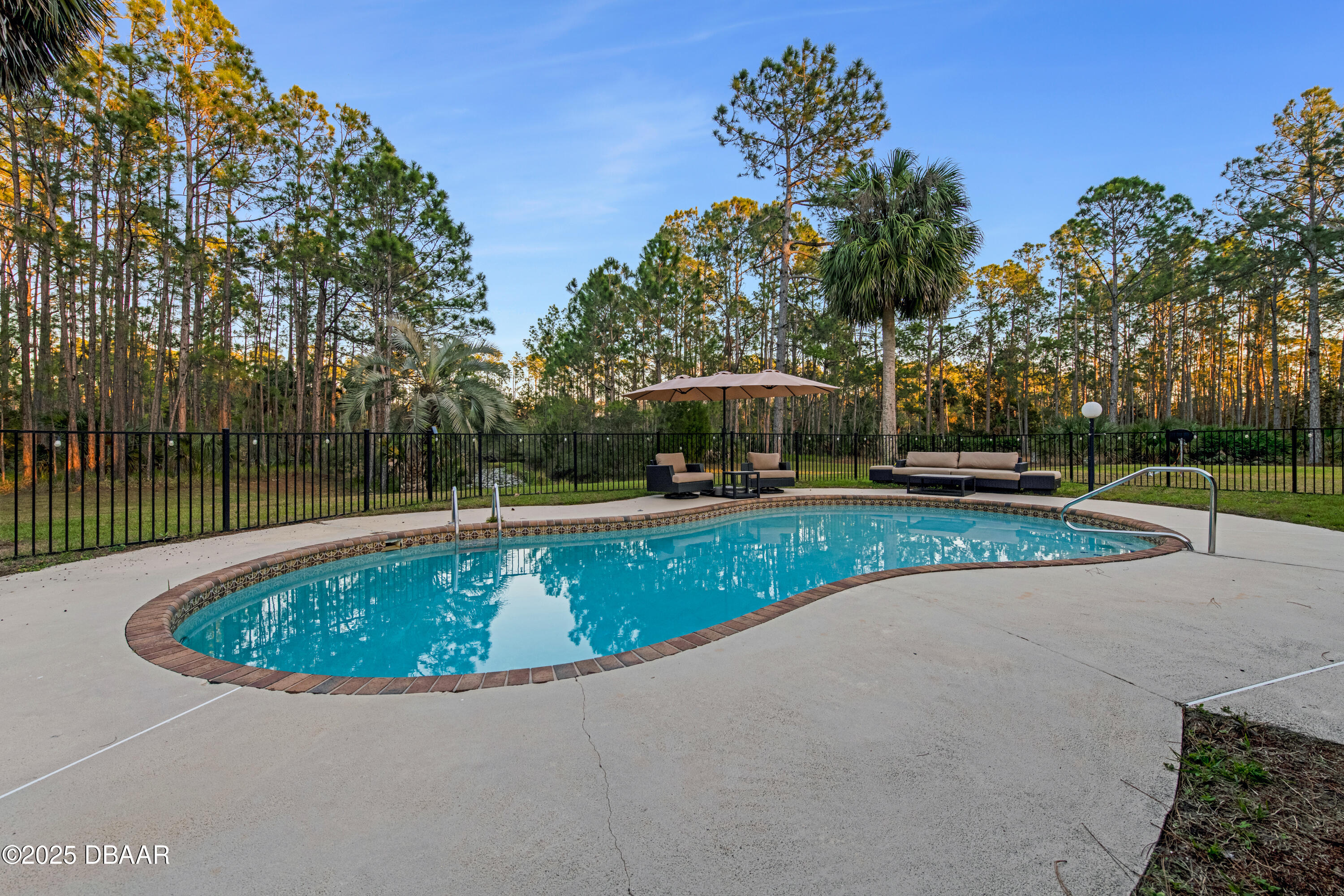 46 Winchester Road Ormond Beach, FL 32174 - Photo 7 of 92 a view of a swimming pool with a yard