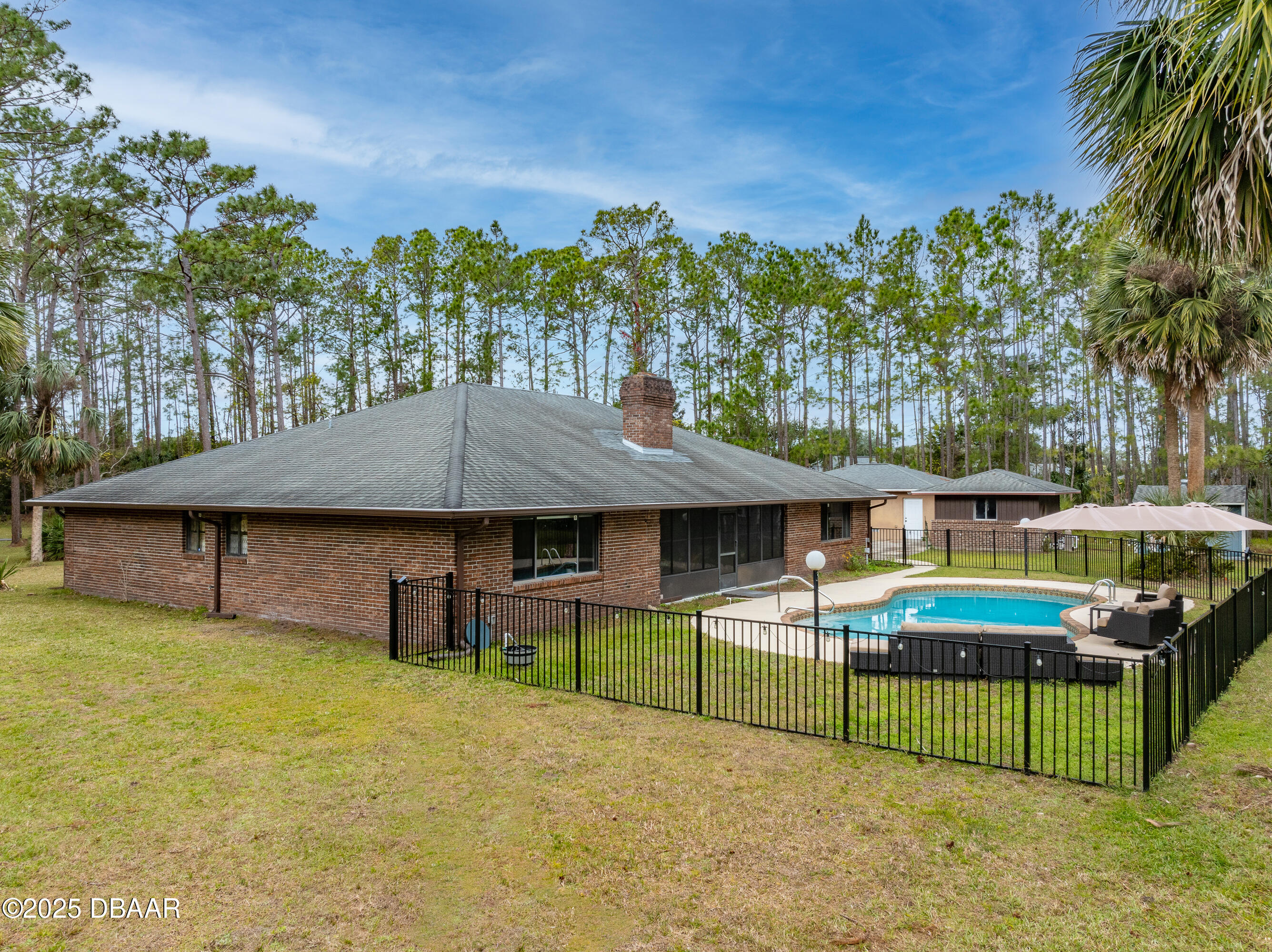 46 Winchester Road Ormond Beach, FL 32174 - Photo 72 of 92 a front view of a house with a yard table and chairs