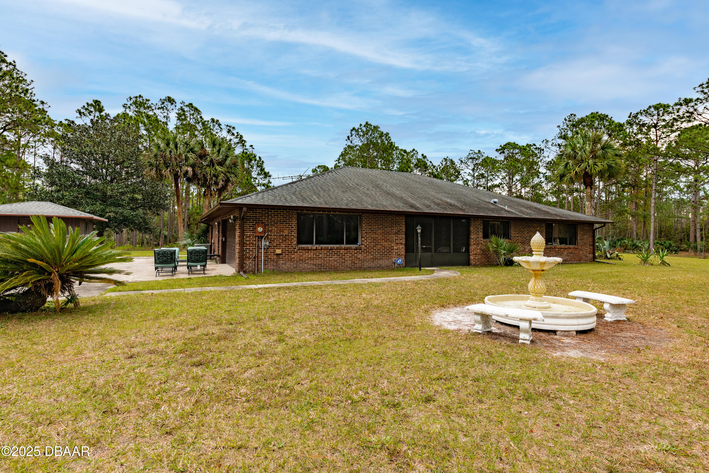 46 Winchester Road Ormond Beach, FL 32174 - Photo 78 of 92 a front view of a house with a yard table and chairs