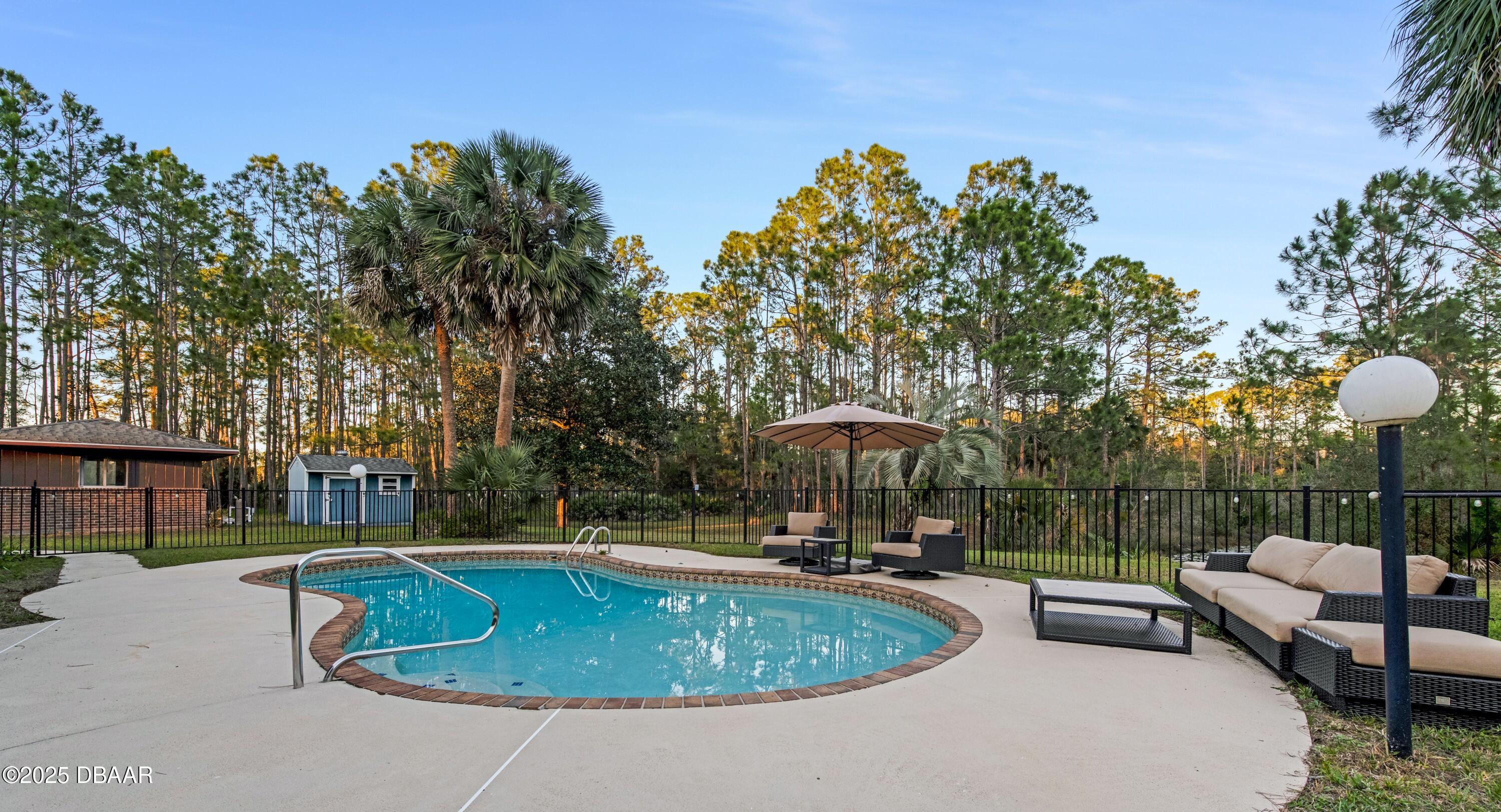 46 Winchester Road Ormond Beach, FL 32174 - Photo 8 of 92 a view of a swimming pool with a patio