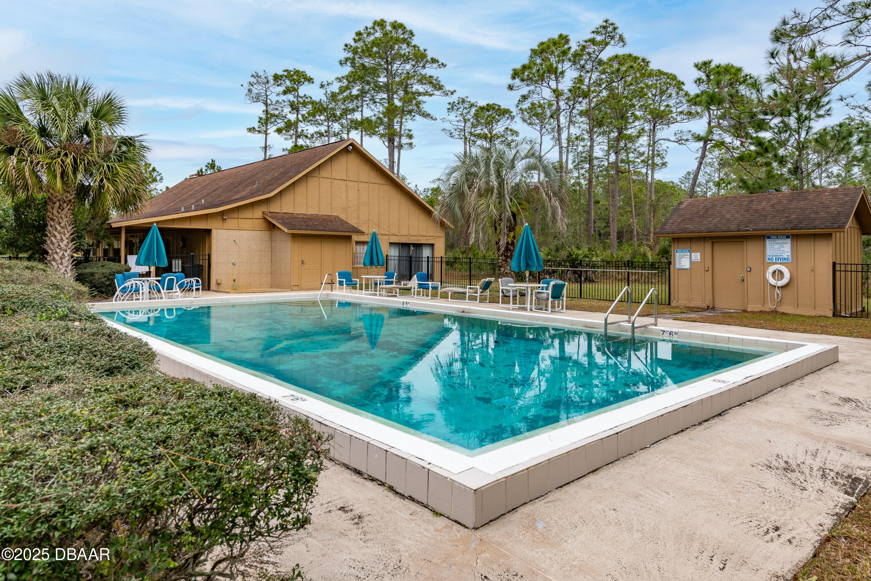 46 Winchester Road Ormond Beach, FL 32174 - Photo 85 of 92 a view of a house with a yard and potted plants
