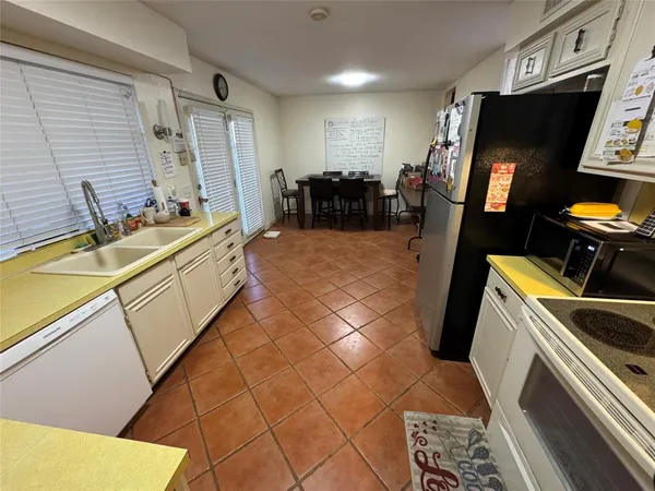 a kitchen with a refrigerator and a stove