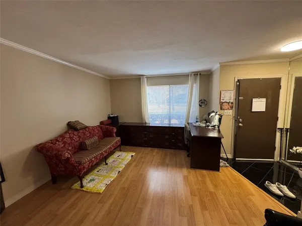 a living room with furniture window and wooden floor