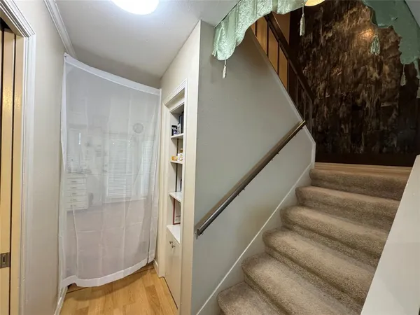 a view of staircase with lots of frames on wall