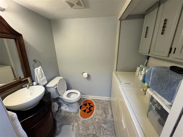 a bathroom with a sink a toilet and a mirror