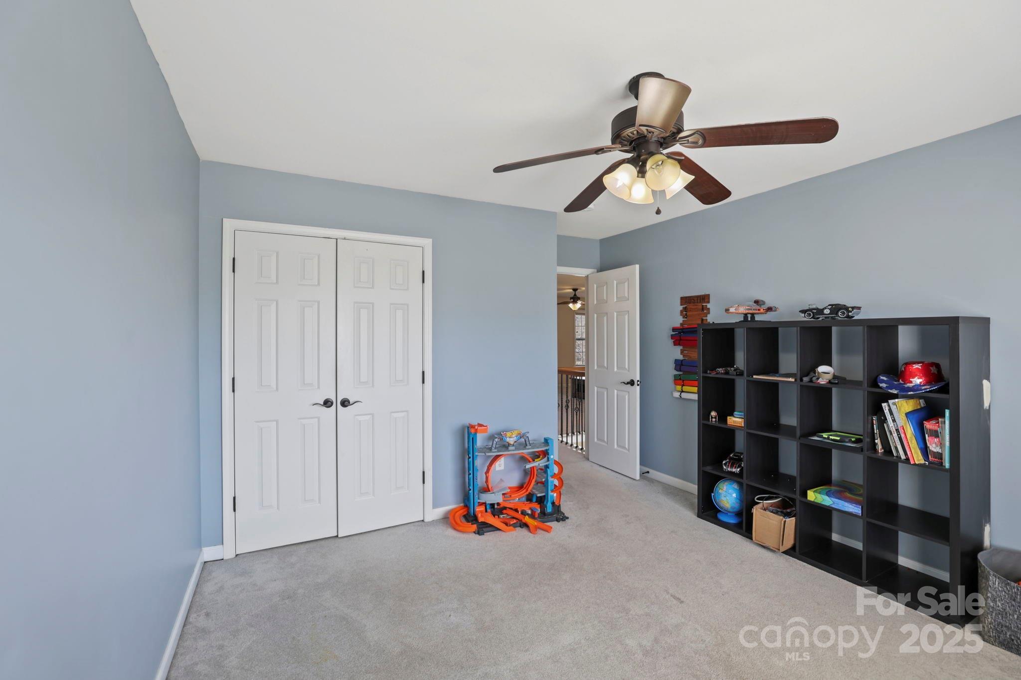 243 Wildbriar Road Fletcher, NC 28732 - Photo 26 of 36 a children room with toys and a ceiling fan
