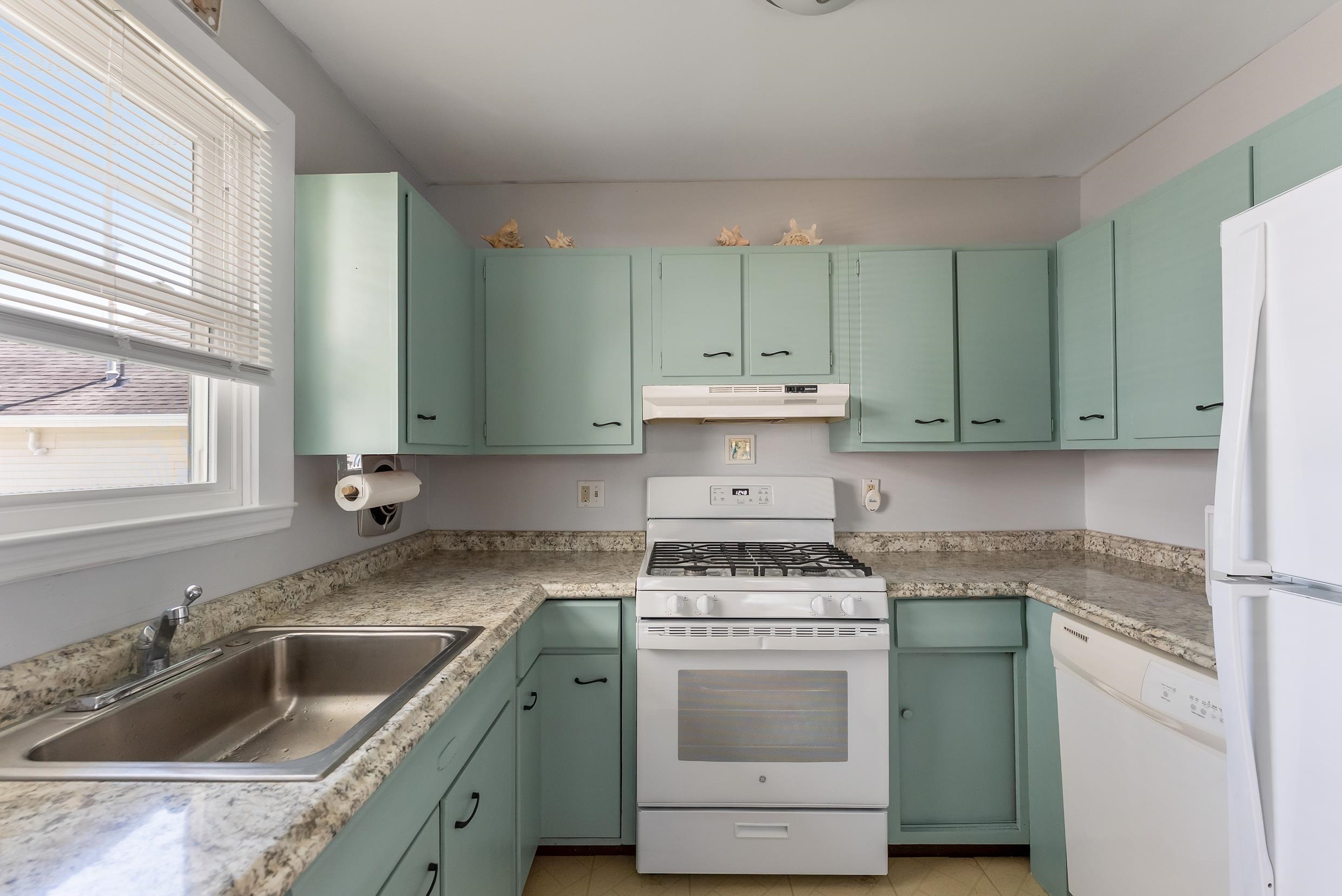 647 Barry Road Avalon, NJ 08202 - Photo 10 of 25 a kitchen with a sink stove and cabinets