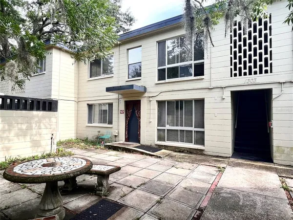 a view of a patio with table and chairs and wooden floor