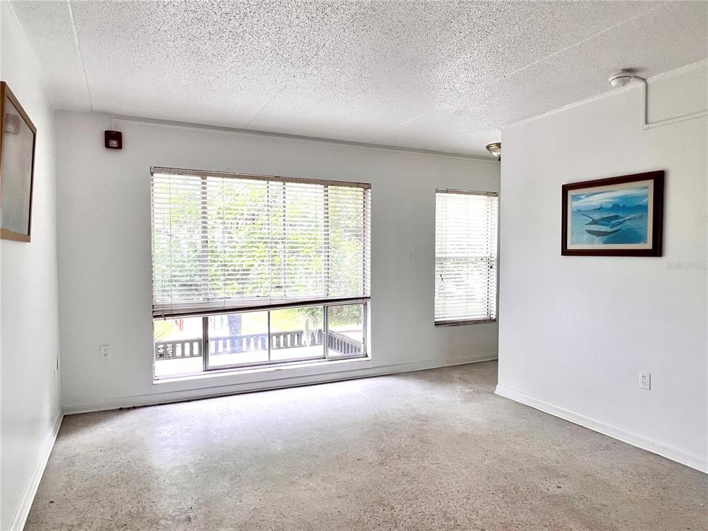 1303 Northwest 6th Street, Unit 4 Gainesville, FL 32601 - Photo 3 of 14 an empty room with windows