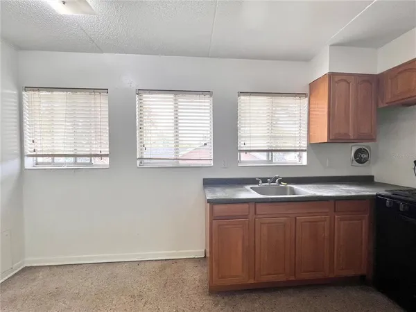 a kitchen with a sink stove and cabinets