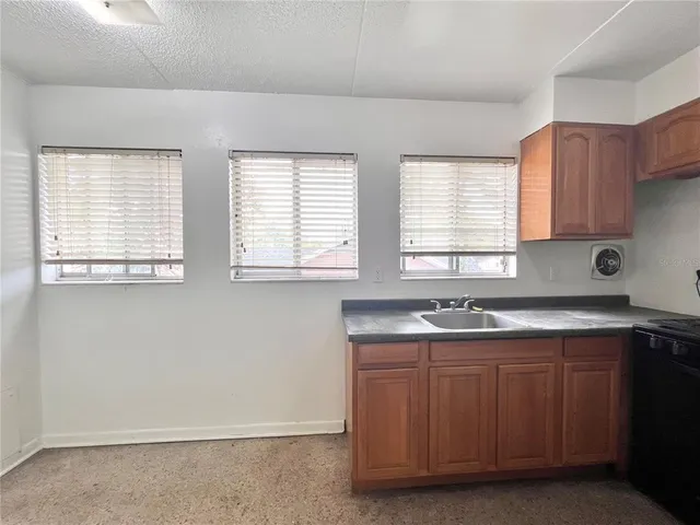 a kitchen with a sink stove and cabinets