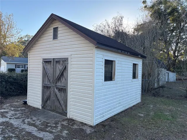 a view of a white house with a yard and garage