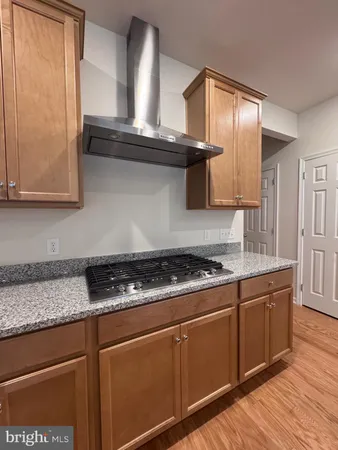 a stove top oven sitting inside of a kitchen