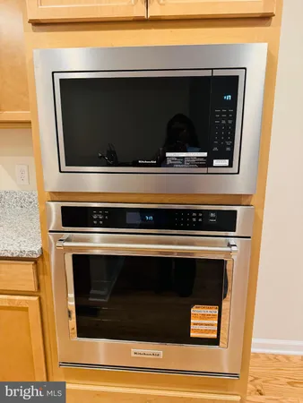 a living room with a stove and a microwave