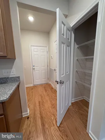 a view of hallway with wooden floor