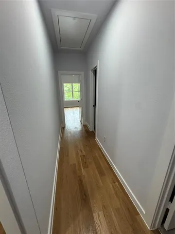 a view of hallway with wooden floor