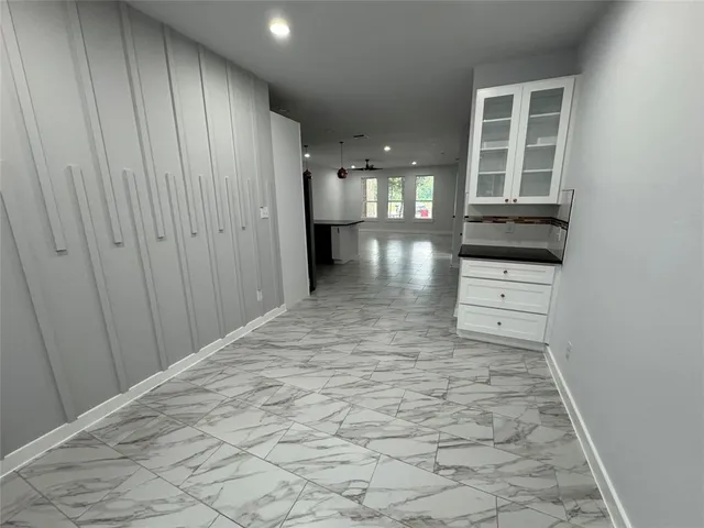 a view of hallway with stairs and wooden floor