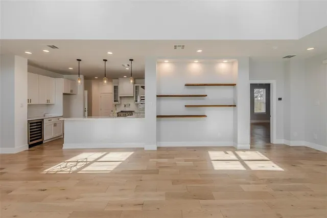 a view of kitchen with kitchen island wooden cabinets and refrigerator