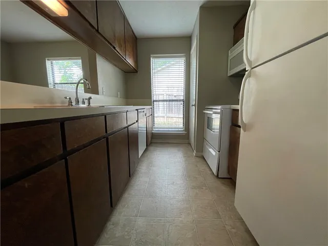 a bathroom with a double vanity sink and mirror