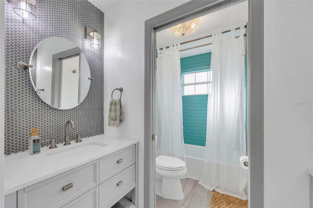 11243 Preston Cove Road Clermont, FL 34711 - Photo 17 of 72 a bathroom with a double vanity sink mirror and toilet