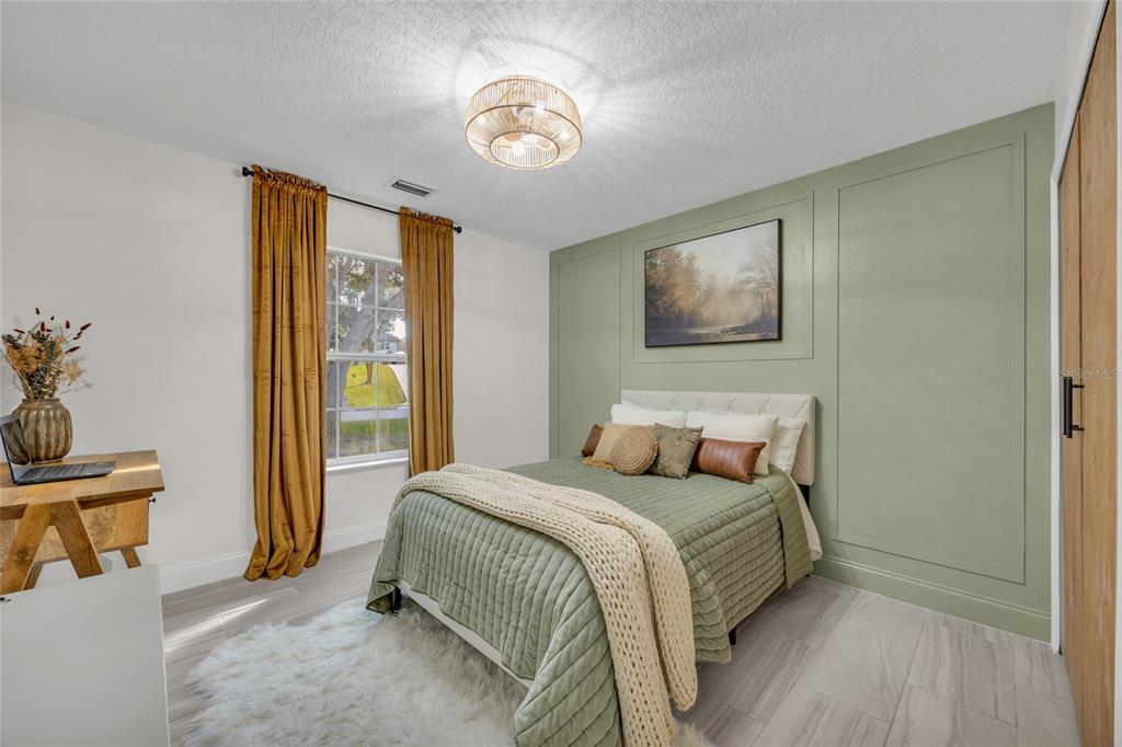 11243 Preston Cove Road Clermont, FL 34711 - Photo 19 of 72 a bedroom with a bed and a window