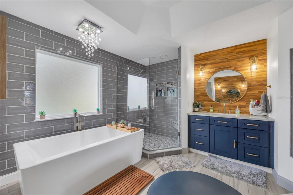 11243 Preston Cove Road Clermont, FL 34711 - Photo 35 of 72 a spacious bathroom with a tub sink and mirror