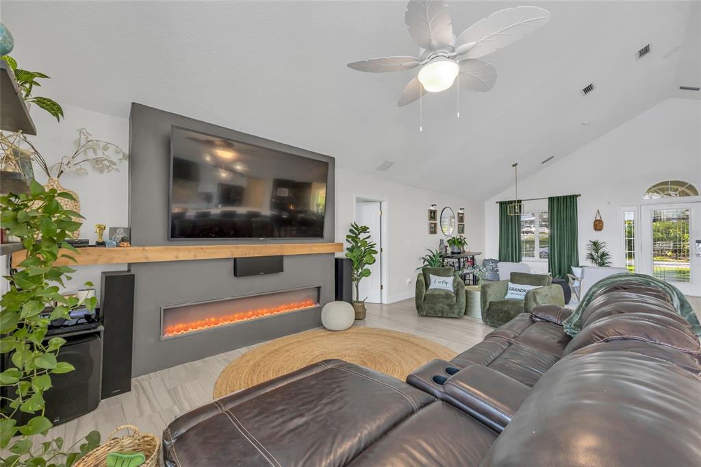 11243 Preston Cove Road Clermont, FL 34711 - Photo 38 of 72 a living room with furniture and a flat screen tv