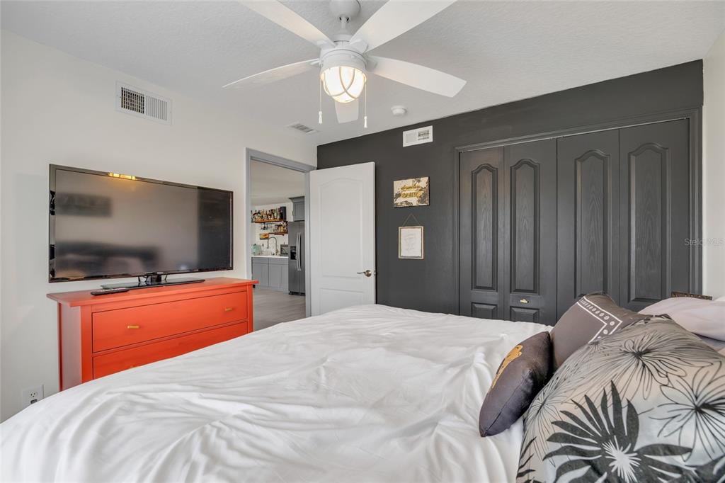 11243 Preston Cove Road Clermont, FL 34711 - Photo 41 of 72 a bedroom with a bed and a flat screen tv