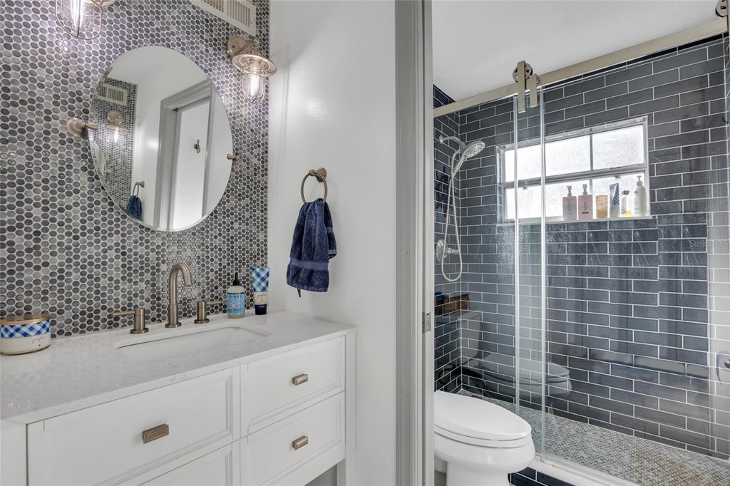 11243 Preston Cove Road Clermont, FL 34711 - Photo 42 of 72 a bathroom with a toilet a sink and mirror