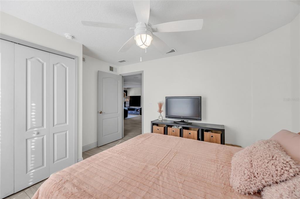 11243 Preston Cove Road Clermont, FL 34711 - Photo 43 of 72 a bedroom with a bed and a flat screen tv