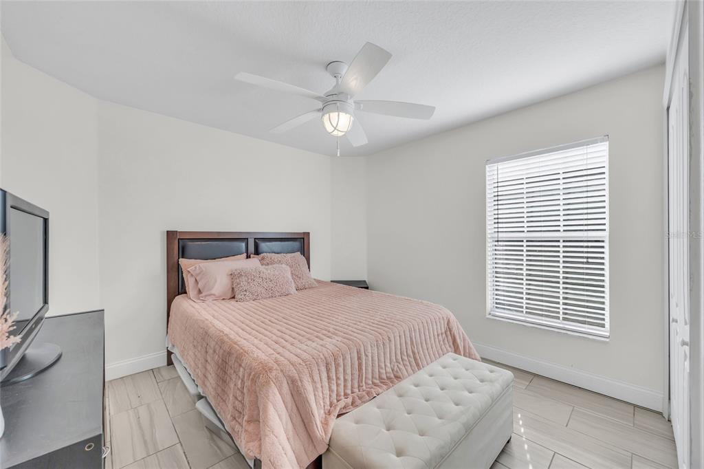 11243 Preston Cove Road Clermont, FL 34711 - Photo 44 of 72 a bedroom with a large bed and a window