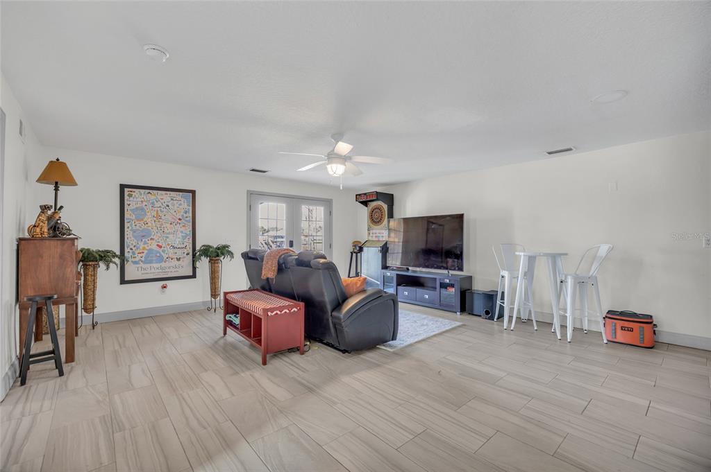 11243 Preston Cove Road Clermont, FL 34711 - Photo 45 of 72 a living room with furniture and a flat screen tv
