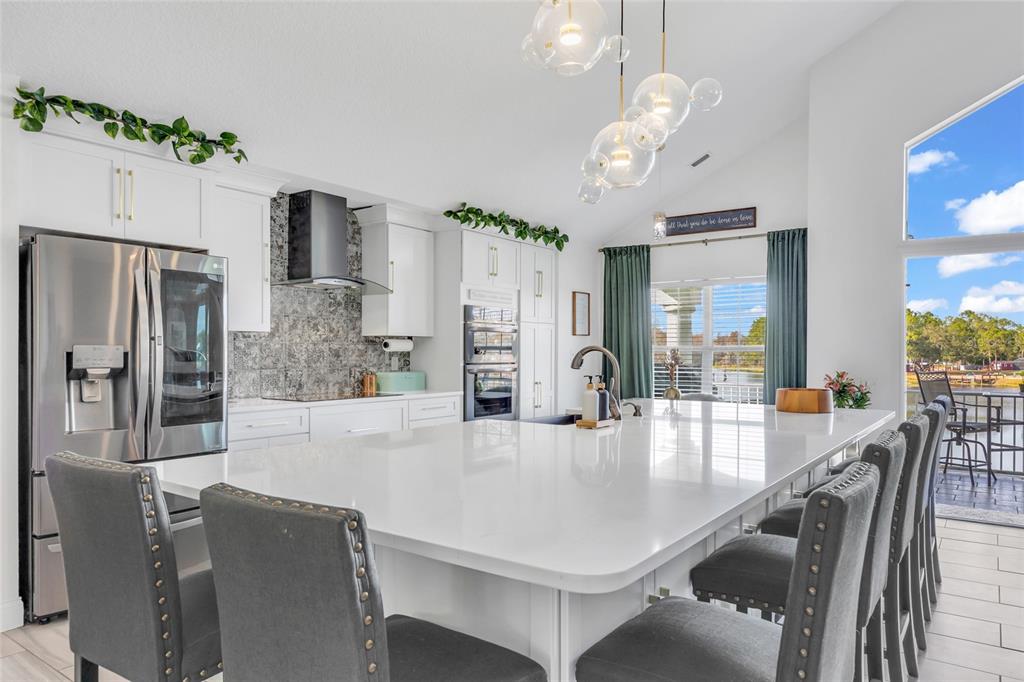 11243 Preston Cove Road Clermont, FL 34711 - Photo 5 of 72 a large kitchen with kitchen island a large counter top appliances and cabinets