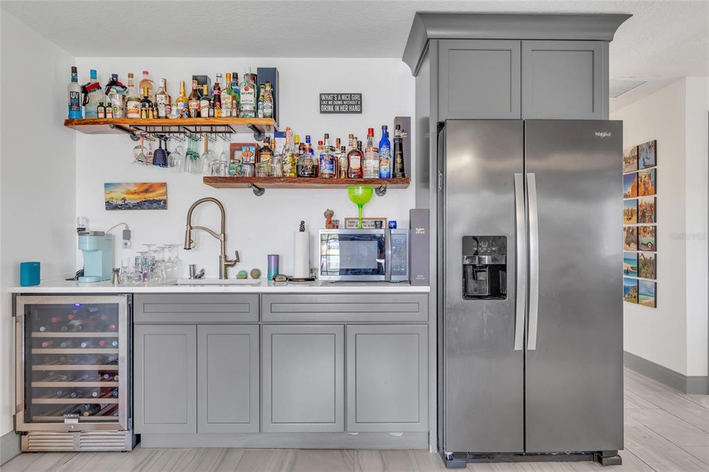 11243 Preston Cove Road Clermont, FL 34711 - Photo 69 of 72 a kitchen with stainless steel appliances a refrigerator and a sink