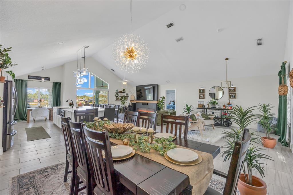11243 Preston Cove Road Clermont, FL 34711 - Photo 7 of 72 a dining room with furniture a rug and a chandelier