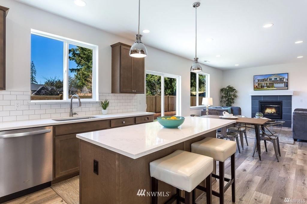 4900 Northeast 1st Street Renton, WA 98059 - Photo 5 of 14 a kitchen with a table chairs refrigerator and microwave