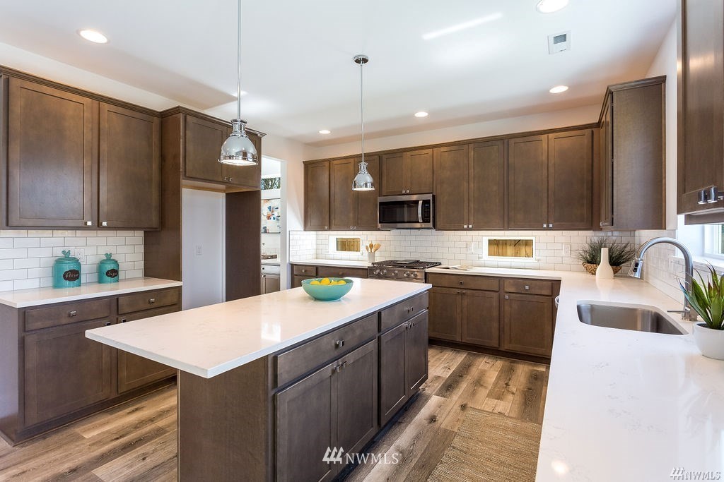 4900 Northeast 1st Street Renton, WA 98059 - Photo 6 of 14 a kitchen with a sink a stove a refrigerator and a refrigerator