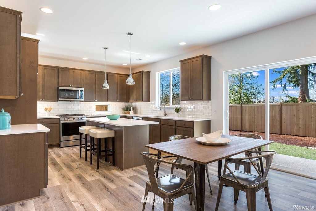 4900 Northeast 1st Street Renton, WA 98059 - Photo 7 of 14 a kitchen with a dining table chairs and refrigerator