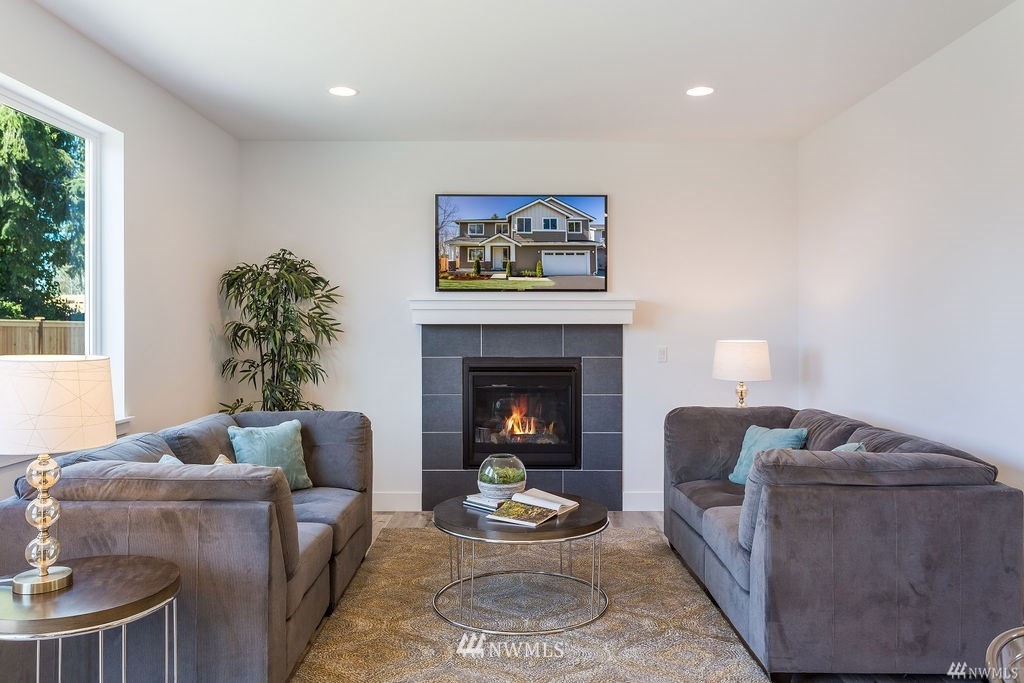 4900 Northeast 1st Street Renton, WA 98059 - Photo 9 of 14 a living room with furniture and a fireplace
