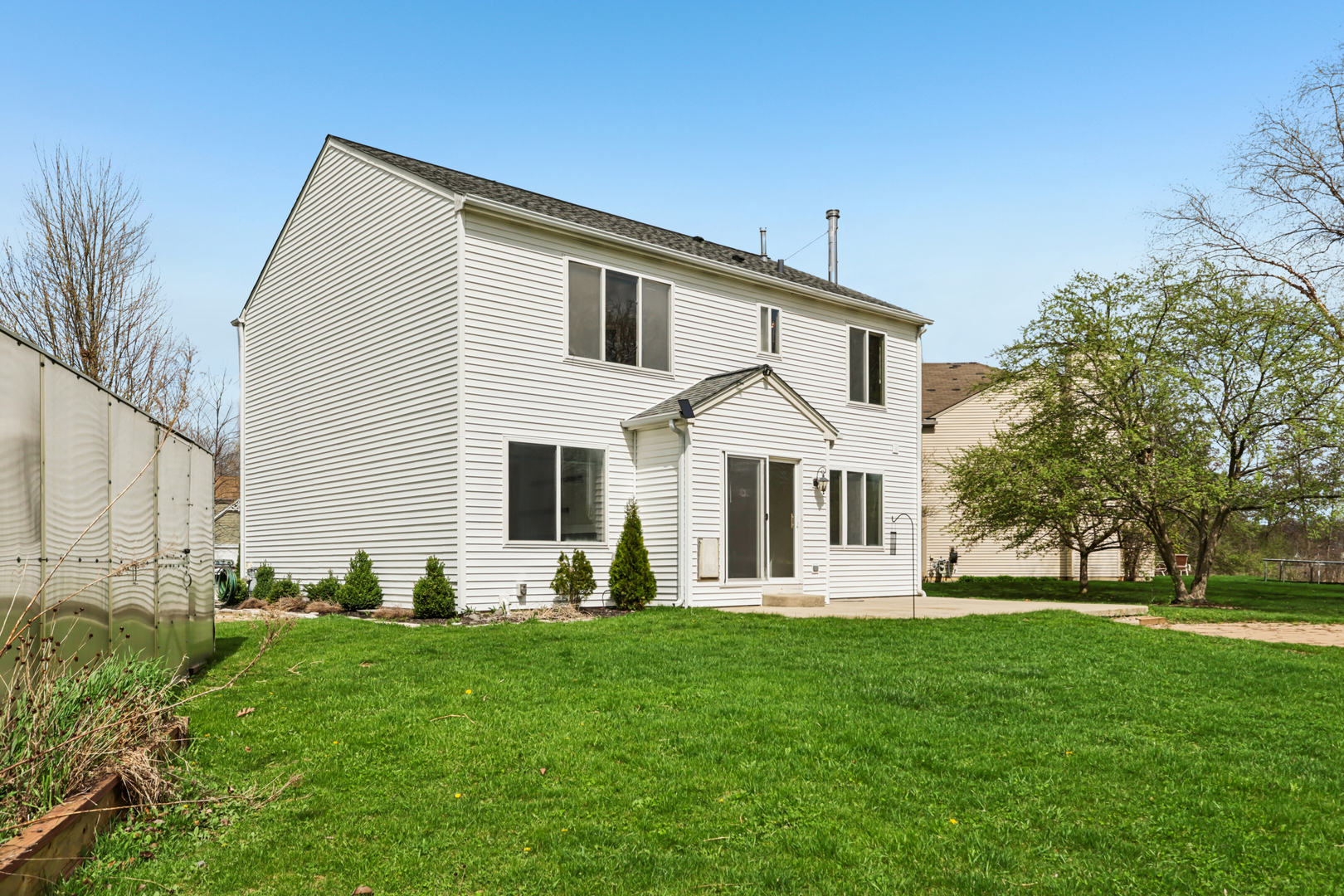 257 Indian Ridge Lane Lake Villa, IL 60046 - Photo 18 of 38 a front view of a house with a yard and trees