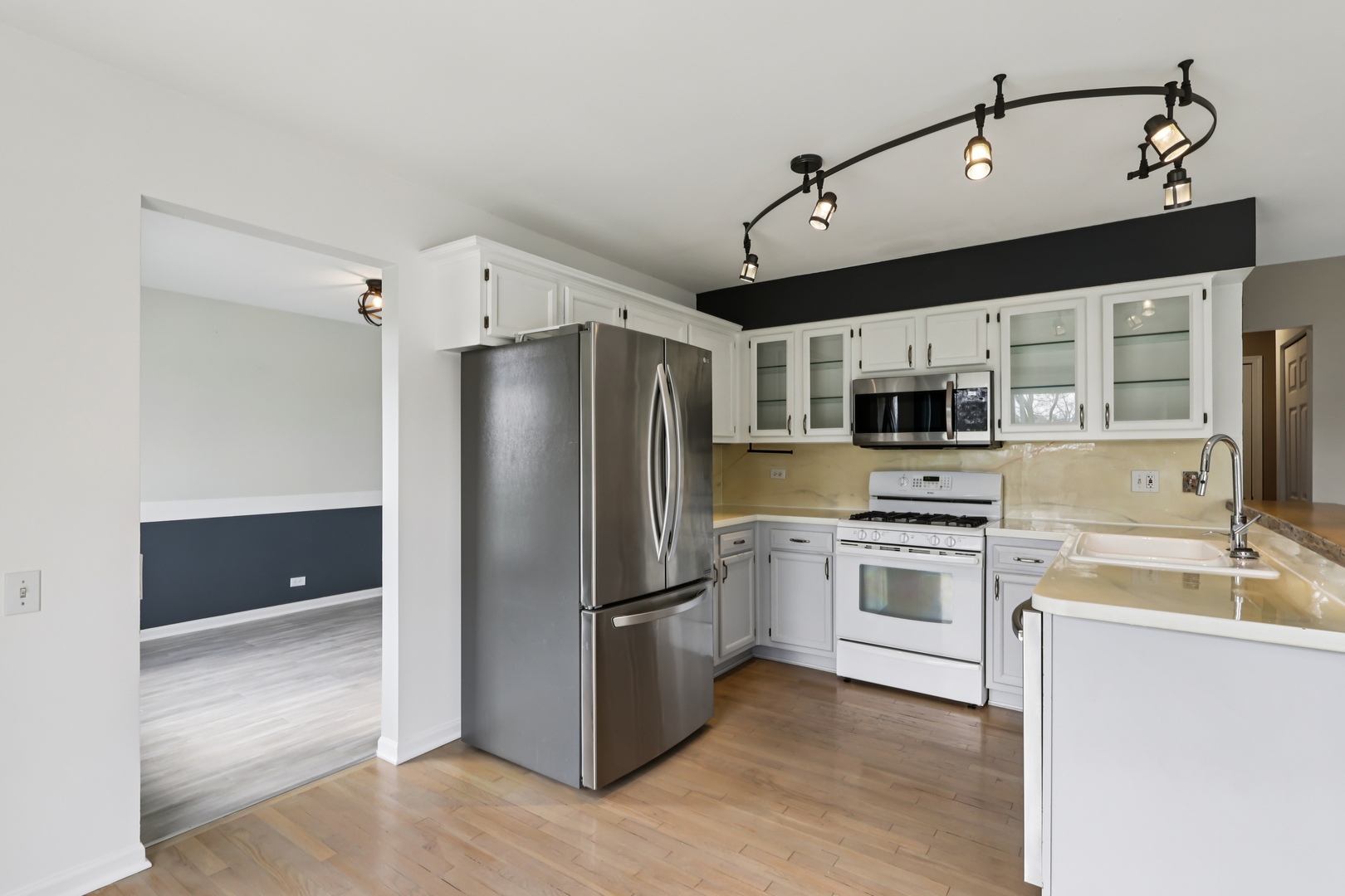 257 Indian Ridge Lane Lake Villa, IL 60046 - Photo 2 of 38 a kitchen with stainless steel appliances a refrigerator sink and stove