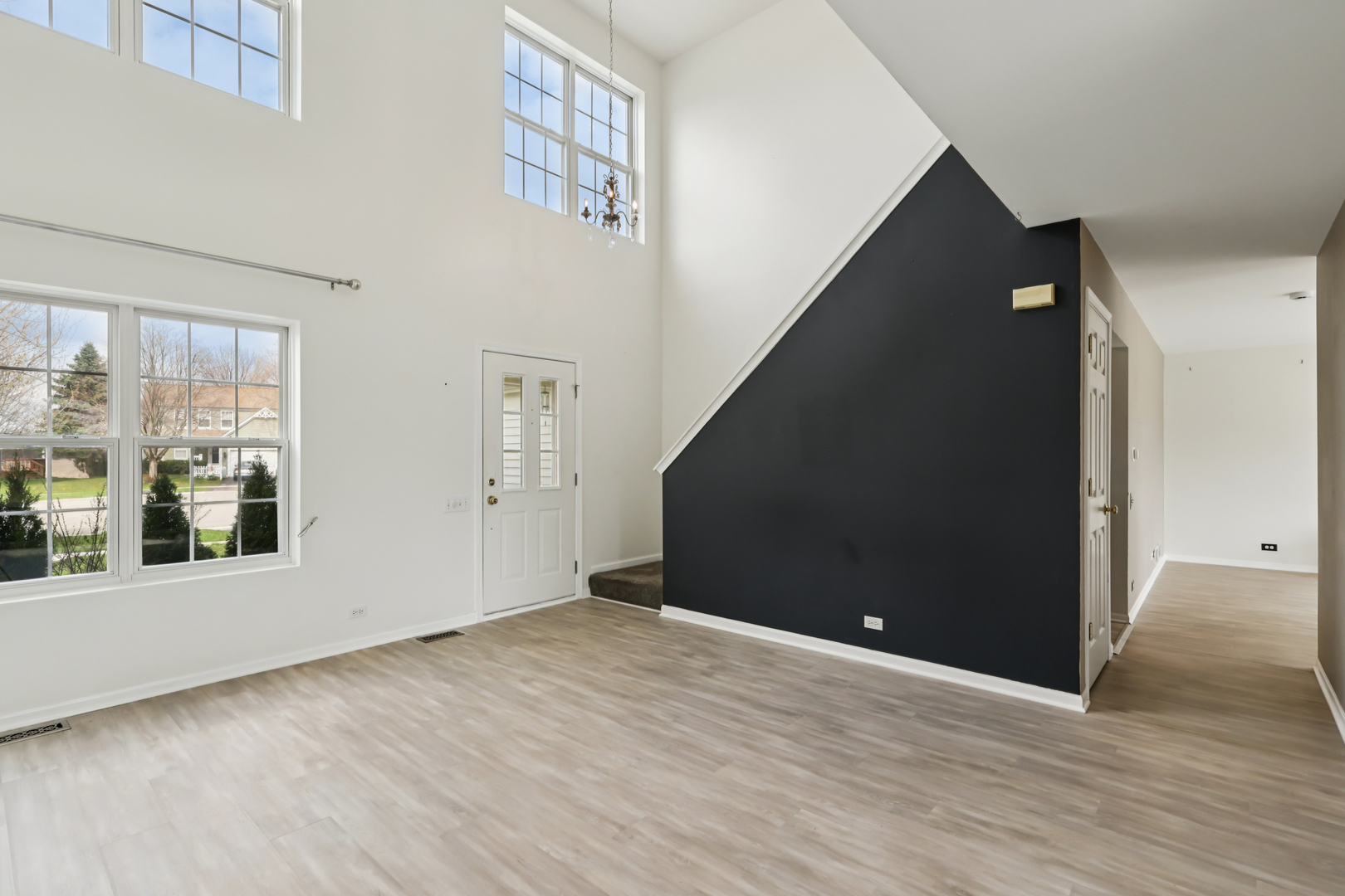 257 Indian Ridge Lane Lake Villa, IL 60046 - Photo 21 of 38 a view of a big room with wooden floor and windows