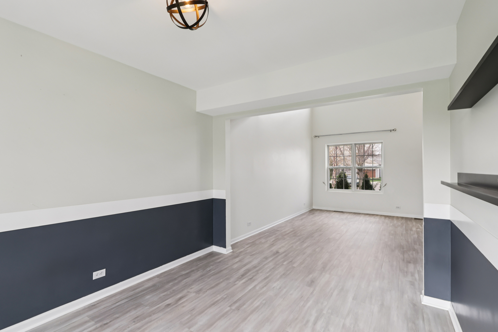 257 Indian Ridge Lane Lake Villa, IL 60046 - Photo 7 of 38 an empty room with wooden floor and windows