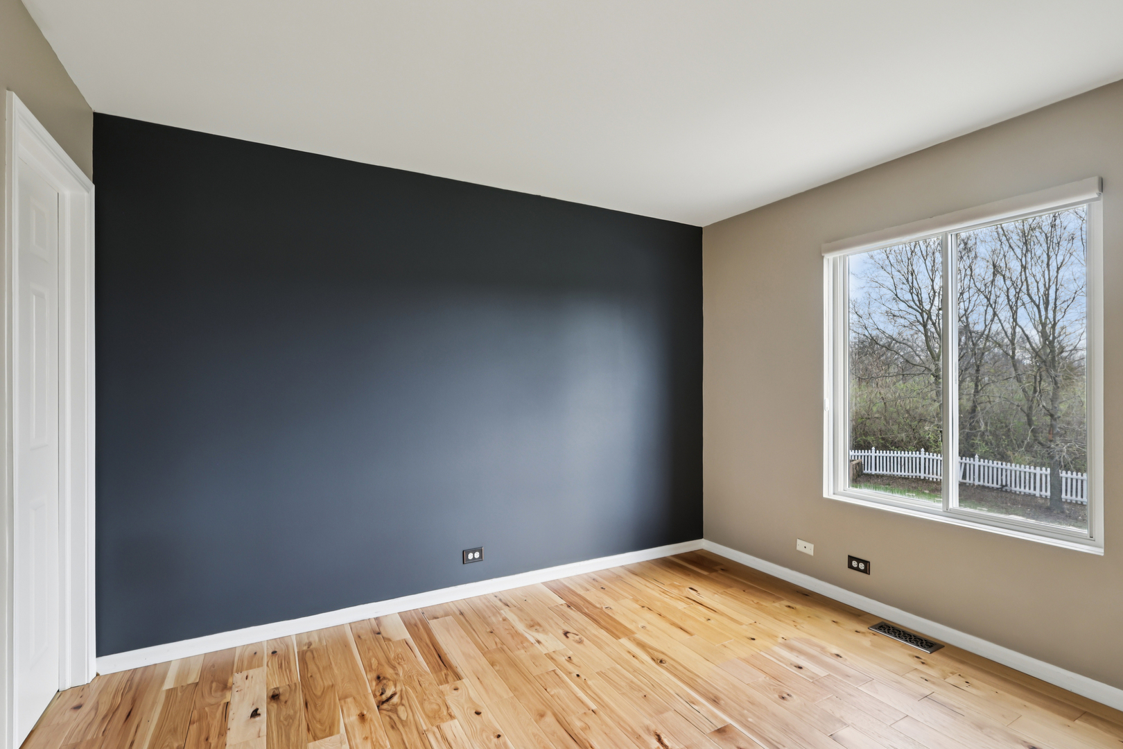 257 Indian Ridge Lane Lake Villa, IL 60046 - Photo 10 of 38 a view of an empty room with wooden floor and a window