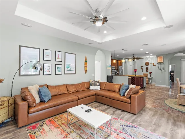 a living room with furniture and a chandelier