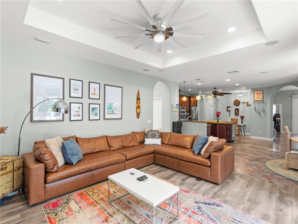 4676 Pebble Bay South, Unit BAY Vero Beach, FL 32963 - Photo 18 of 36 a living room with furniture and a chandelier